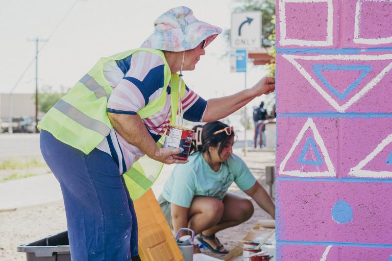 Two women painting at St. Vincent de Paul in Mesa during Love Your City Day in September 2025