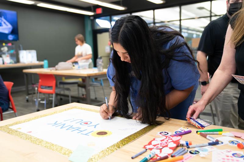 Photo of woman making a thank you card for first responders for National Day of Service  