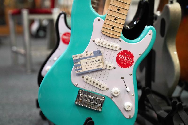 Photo of Jimmy Eat World library card with Fender guitar 